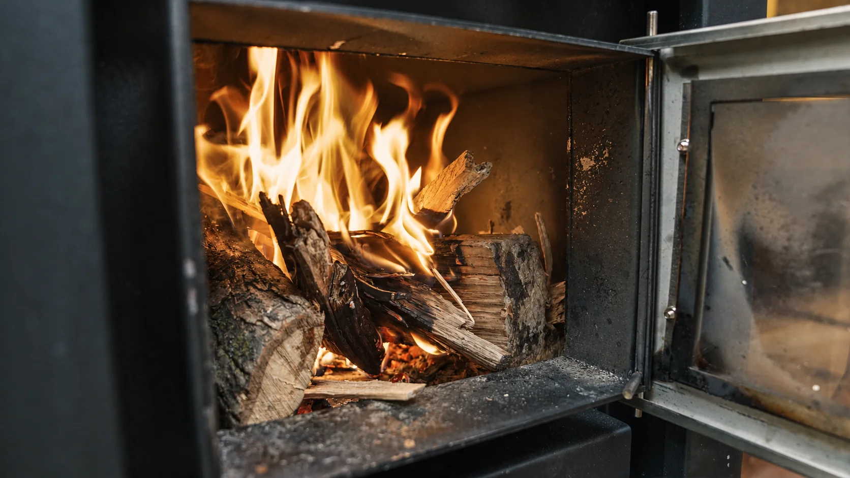 Flames and glowing wood inside the sauna stove