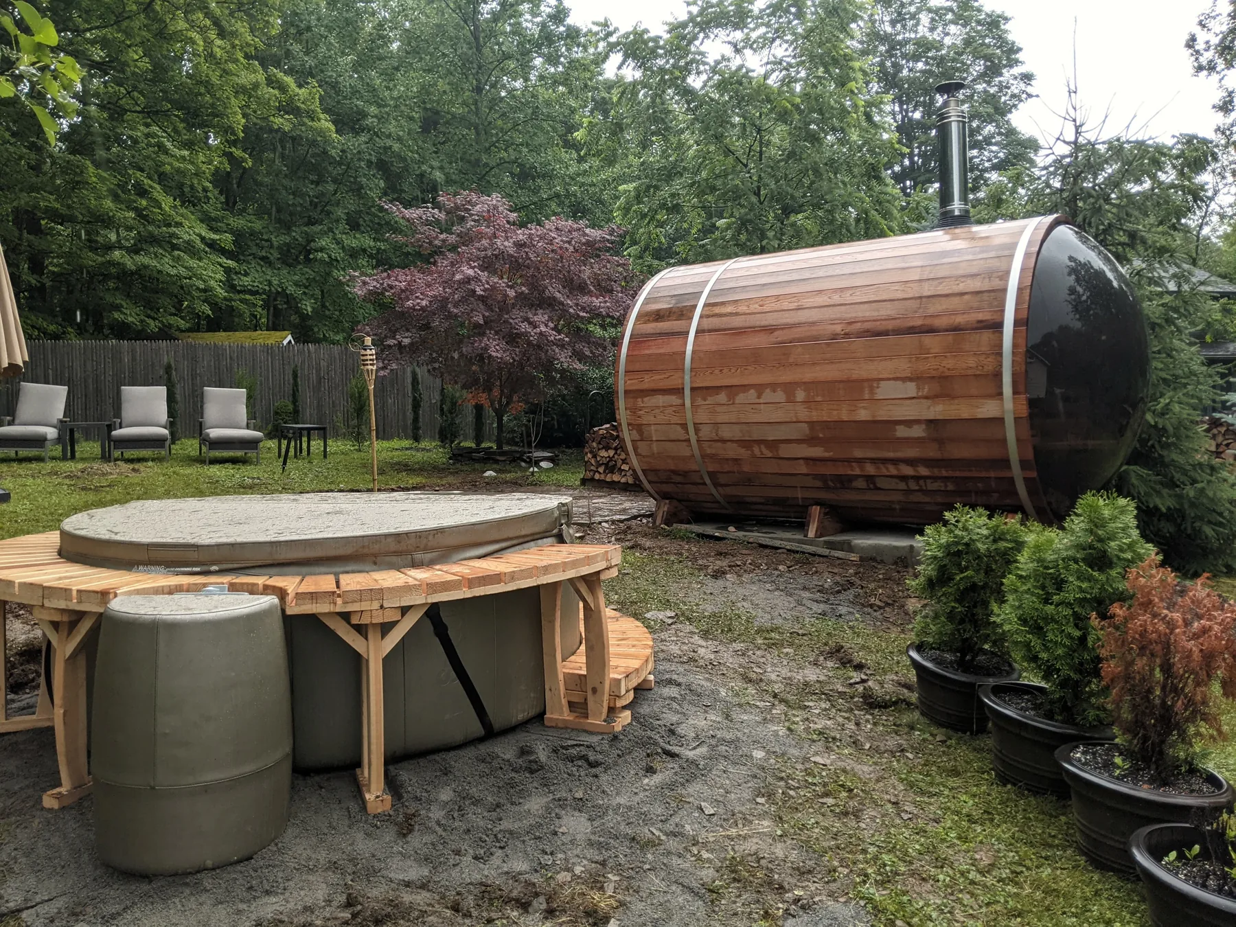 Completed barrel sauna in a green Woodstock backyard
